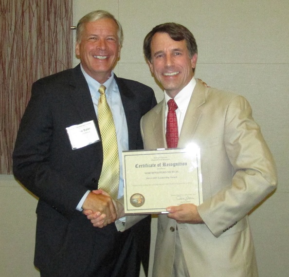 Jerry Baier accepting a Leadership Award from the Commissioner on behalf of Northwestern Mutual for holding the most High Impact COIN Qualified Investments in 2012.