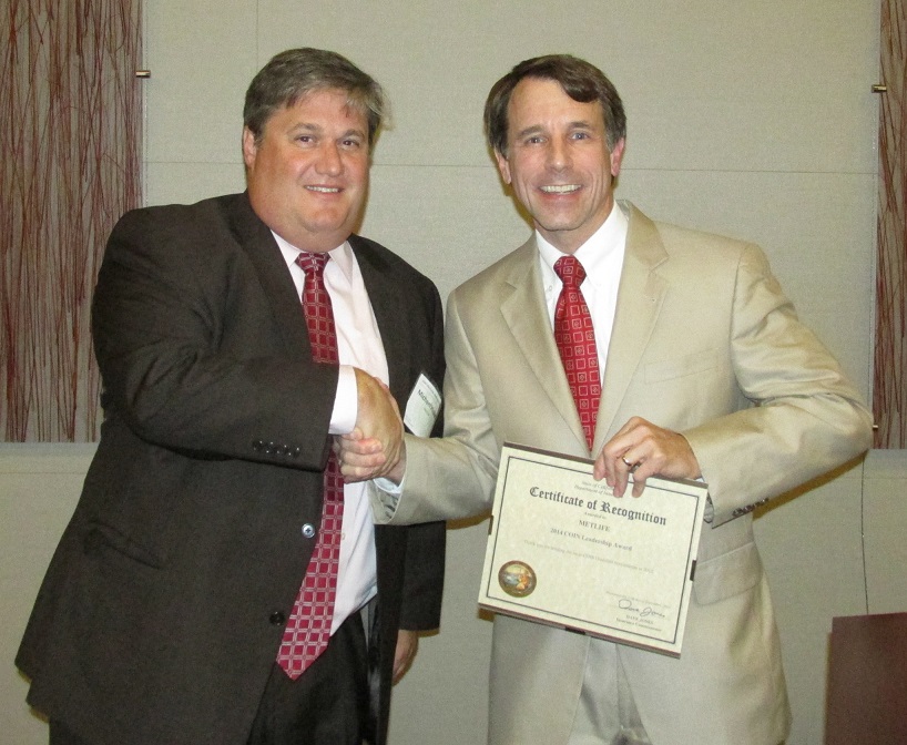 Michael Hickey accepting a Leadership Award from the Commissioner on behalf of MetLife for holding the most COIN Qualified Investments in 2012.